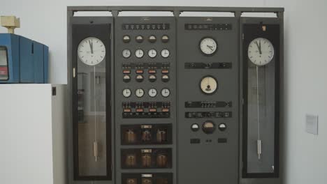Double-clock-on-exhibition-Inside-National-Technical-Museum-in-Prague,-Czech-Republic,-tilt-up-shot