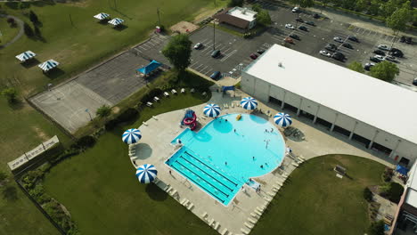 Outdoor-pool-in-american-suburb,-aerial-orbit