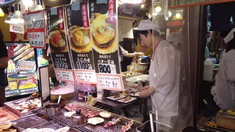 Japanese-Chef-Cooks-Traditional-Grilled-Meat,-Nishiki-Street-Market-Kyoto-Japan