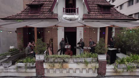 Jazz-septet-band-plays-music-on-bar-balcony-in-Sao-Paulo,-Brazil