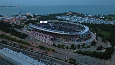 Aerial-overview-of-traffic-on-the-Lake-Shore-drive-and-the-Soldier-field-Stadium,-blue-hour-in-Chicago,-USA
