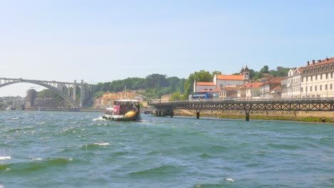 Blick-Auf-Porto-über-Den-Fluss-Douro-Mit-Traditionellem-Rabelo-Boot---POV