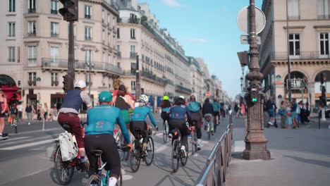 Cyclists-Group-Riding-on-Paris-Streets,-Touring-Urban-Scenery,-Exercise-and-Tourism-Experience-in-France's-Capital