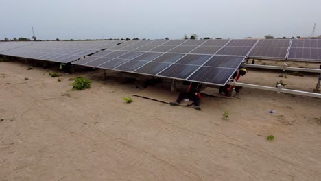 Engineers-And-Technicians-At-Work-Installing-Solar-Panels-On-Mount-At-The-Solar-Farm-In-Gambia,-West-Africa