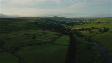 Establishing-Drone-Shot-Forward-Over-Yorkshire-Dales-Hills-and-Fields-at-Golden-Hour