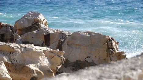 Close-up-of-foamy-waves-of-the-Adriatic-Sea-crashing-against-the-shore-of-an-Albanian-beach