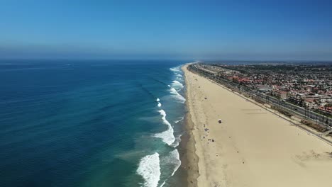 Very-high-view-over-Huntington-Beach-with-almost-no-people-and-some-large-waves-breaking-on-the-shore