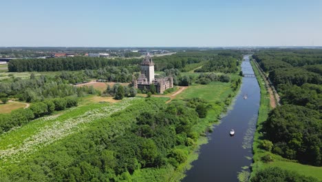 Aerial-drone-shot-above-a-nature-park,-water-canal,-abandoned-kastel-of-Almere-city,-province-Flevoland,-Netherlands