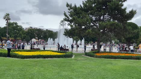 Visitors-explore-and-take-photos-of-the-surrounding-of-Sultan-Ahmet-Park-and-the-beautiful-water-fountain-in-Istanbul,-Turkey