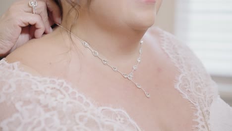 Bride-Having-Her-Diamond-Necklace-Put-On-By-Her-Mother-in-Slow-Motion