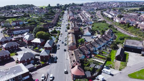 Drone-view-flying-over-Harwich-Town-with-houses-and-cars-below