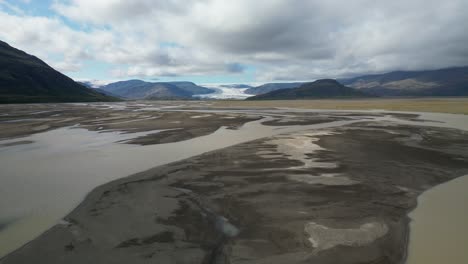 Backwards-view-of-glacier-river-streaming-across-the-valley-in-south-Iceland