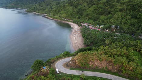 Coastal-sea-ocean-water-view-road-to-sandy-calm-beach,-philippines-aerial