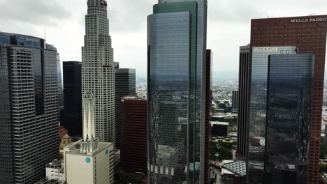 Drone-pulling-back-from-financial-buildings-in-downtown-Los-Angeles,-cloudy-USA