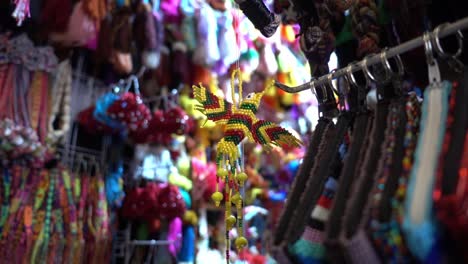 Slowmotion-bokeh-shot-of-a-handmade-bird-ornament-hanging-for-sale-in-a-Mexican-store