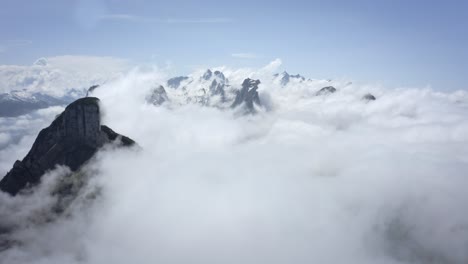Drone-aerial-above-the-clouds-and-mountains-in-Switzerland