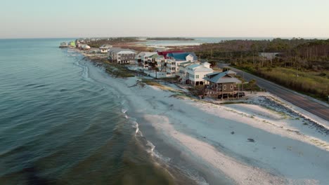 Aerial-shot-of-luxurious-beach-front-homes-raised-up-on-stilts-on-the-Gulf-of-Mexico