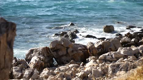 Foaming-waves-of-the-Adriatic-Sea-crash-against-the-rocky-shore-of-an-Albanian-beach