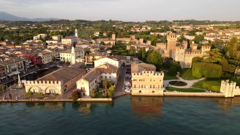 Drone-shot-of-a-crowded-market-at-the-boulevard-on-Lake-Garda-at-sunset