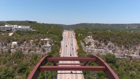 Fly-over-reveal-drone-shot-of-the-Pennybacker-Bridge-in-Austin,-Texas