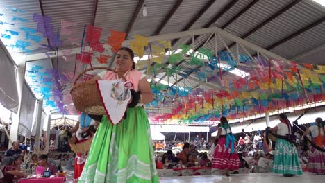 Slow-motion-shot-of-Mexican-women-handing-out-gifts-at-guelaguetza