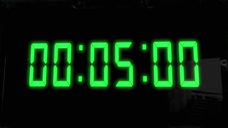 High-quality-CGI-render-of-a-digital-countdown-timer-on-a-wall-mounted-screen,-with-glowing-green-numbers,-counting-down-from-10-to-zero,-with-with-camera-slowly-pushing-in-dramatically