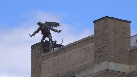 A-metal-statue-of-a-flying-monkey-adorns-the-rooftop-of-a-building-in-Burlington,-Vermont