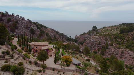 Aerial-View-Of-House-In-The-Mountain-Hill-In-Cala-de-Deia-In-Mallorca,-Spain