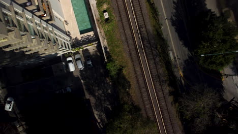 The-drone-takes-off-from-the-parking-lot-next-to-the-railway-tracks