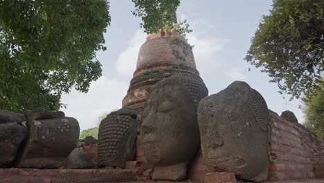 Buddhist-Head-Statues-in-Historic-Ancient-Ruins-of-Ayutthaya,-Thailand