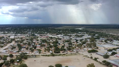Rural-African-town-Aerial-video-with-rain-clouds-in-background