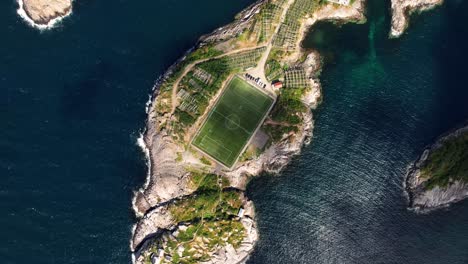 The-magical-Henningsvaer-football-field-seen-from-an-aerial-shot-in-Lofoten,-Norway