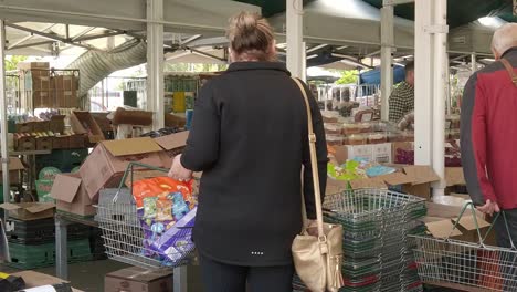 Shoppers-browsing-groceries-on-English-town-market-stalls-during-cost-of-living-crisis-inflation