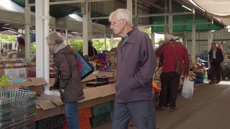 Pensioners-browsing-cheap-groceries-on-town-market-stalls-during-cost-of-living-crisis-inflation