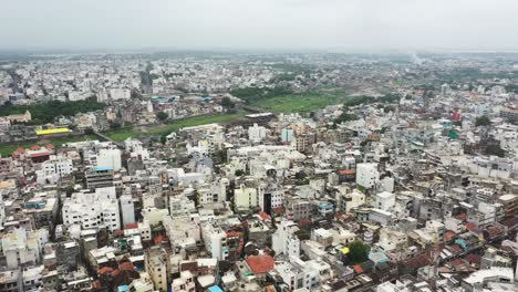 Aerial-view-of-old-Rajkot-city-showing-high-rise-residential-complexes-surrounded-by-old-buildings-and-river-running-through-the-city