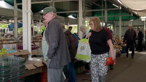 People-browsing-groceries-on-UK-town-market-stalls-during-cost-of-living-crisis-inflation