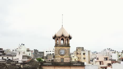 Aerial-view-of-Raya-Naka-Tower-with-the-drone-camera-moving-backwards-and-the-entire-tower-visible,-this-was-the-main-gate-to-enter-Rajkot-City-during-the-British-era