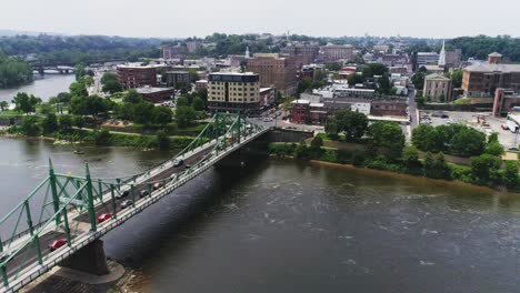 Aerial-view-of-Easton-PA-and-Delaware-River-approaching-city-next-to-the-bridge-over-the-water