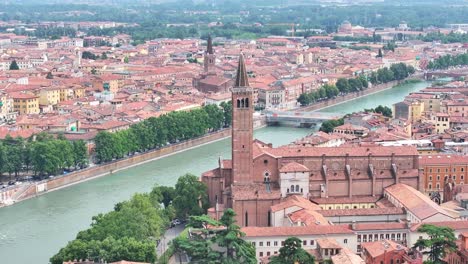 Pointy-clocktower-rising-tall-at-Adige-river-Riva-Del-Garda-Italy
