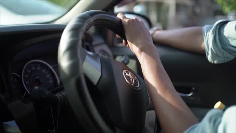 Hands-on-the-steering-wheel-in-car