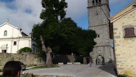 Tourists-and-visitors-at-the-Church-tower-in-the-village-of-Plomin,-Croatia