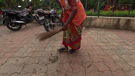 female-RMC-worker-is-sweeping-the-garbage-from-the-road