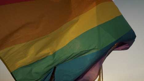 Huge-Rainbow-Pride-Gay-Flag-Waving-Against-Sunny-Horizon