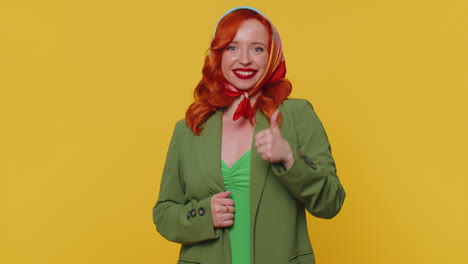 Redheaded-woman-raises-thumbs-up-agrees-or-gives-positive-reply-recommends-advertisement-likes-good