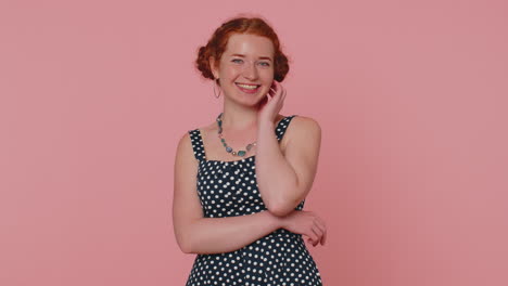 Cheerful-lovely-redheaded-young-woman-fashion-model-in-dress-smiling-and-looking-at-camera-alone
