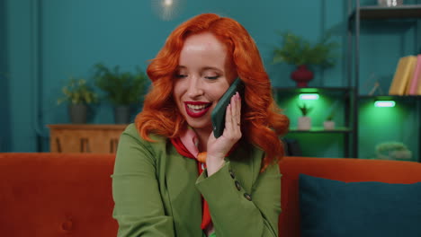 Red-hair-woman-enjoying-smartphone-call-talking,-mobile-phone-conversation-with-friends-at-home