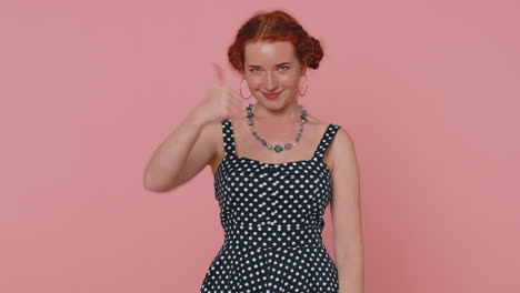 Redheaded-woman-raises-thumbs-up-agrees-or-gives-positive-reply-recommends-advertisement-likes-good