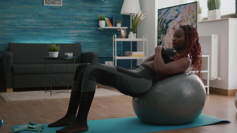 Slim Fit Black Woman Sitting on Yoga Swiss Ball Doing Abs Exercise