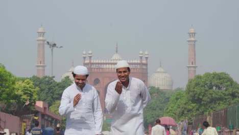Muslim-men-doing-adab-in-front-of-a-mosque-to-the-camera