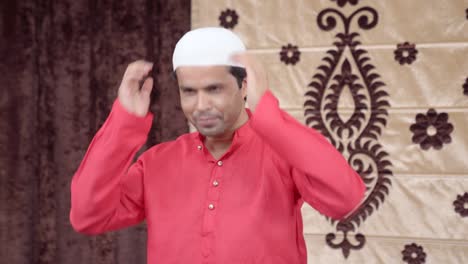Muslim-man-wearing-his-cap-for-the-Eid-rituals